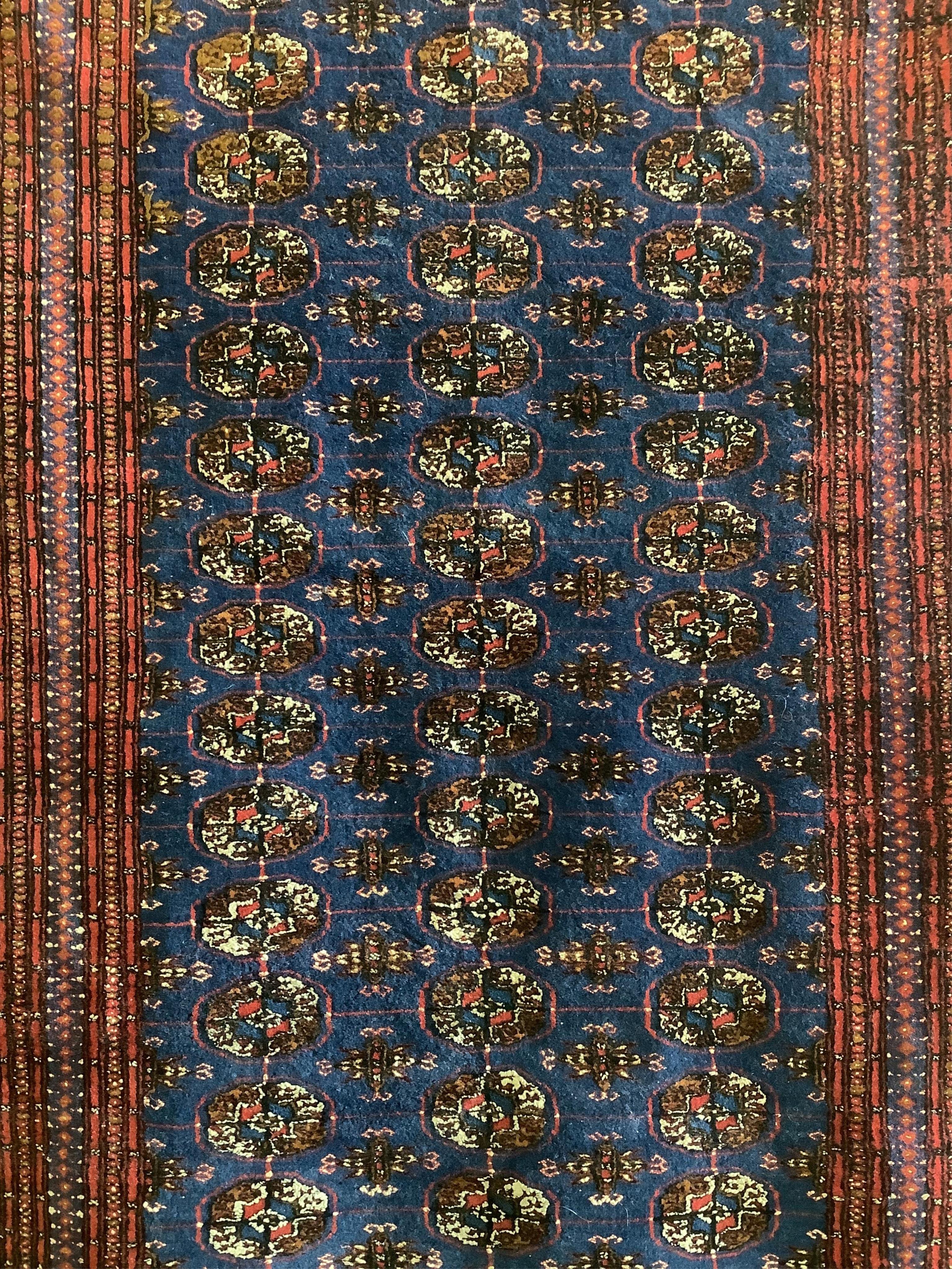 A Bokhara blue ground rug, 189 x 130cm